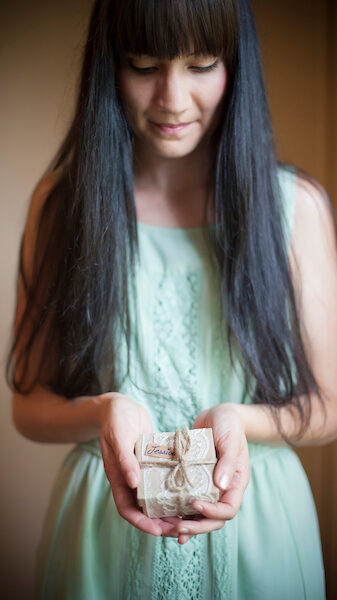 a black haired girl holding a box - Bridal dressing room in Interpretation building