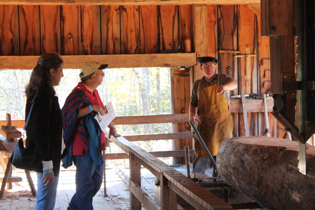 A man shows guest around a barn as part of his employment